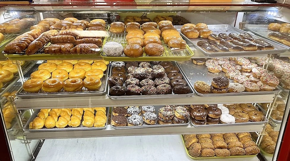 Display case full of fresh donuts
